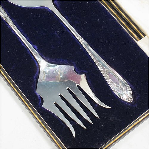 An Antique Sterling Silver serving spoon and fork, having hand-chased neoclassical pattern handles, the spoon with a hand-pierced blade, and the fork with five hand-cut tines, and all sitting in their original cream satin and dark blue velvet-lined presentation box. Made by Roberts & Belk of Sheffield in 1913. The dimensions of this fine hand-made antique pair of serving spoon and fork are length 24cms (9.5 inches), and they weigh a total of approx. 222g (7.2 troy ounces).