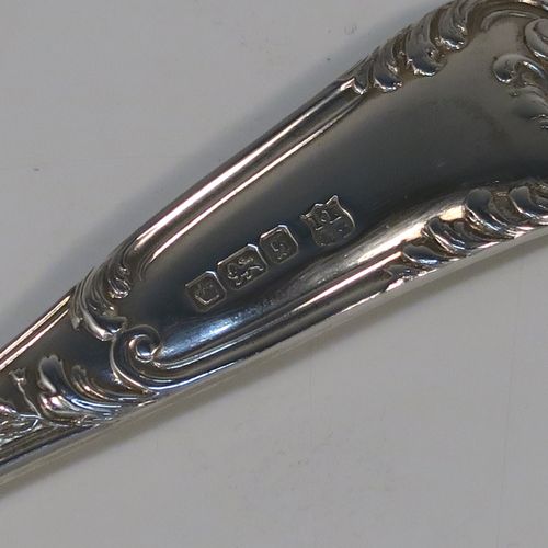 A beautiful pair of Antique Edwardian Sterling Silver serving spoons, having handles with double-struck floral and scroll-work in a Louis style pattern handles, and fluted oval bowls with a gold-gilt wash and hand-engraved floral work, all in their original dark blue satin and velvet-lined presentation box. These wonderful silver serving spoons were made by Thomas Brabury of Sheffield in 1910. The dimensions of this fine hand-made pair of antique silver serving spoons are length 19cms (7.5 inches), and they weigh a total of approx. 97g (3 troy ounces).
