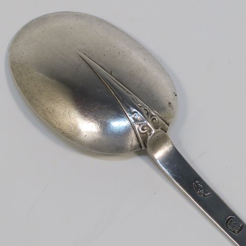 A very handsome Antique James II Sterling Silver Trefid-end table spoon, having a lace-backed rattail pattern bowl, which is slightly worn down on one side (consistent with right-hand usage), together with a trefid terminal having engraved contemporaneous sets of initials on both sides. In original condition with fine patina and colour this elegant James II silver spoon was hallmarked for London in 1688. The dimensions of this fine hand-made antique silver seventeenth century table spoon are length 20cms (8 inches), and it weighs approx. 55g (1.8 troy ounces).