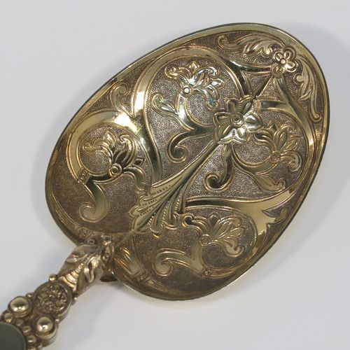 A large and beautiful Antique Victorian Sterling Silver and gold-gilt serving spoon, in the Coronation Anointing pattern with hand-engraved floral decoration to the bowl, and a cast ornate and twisted handle. This fantastic silver and gold-gilt Coronation serving spoon was made by Mappin and Webb of London in 1891. The dimensions of this fine hand-made antique silver Coronation Anointing spoon are length 26 cms (10.25 inches), and it weighs approx. 105g (3.4 troy ounce).