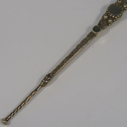 A large and beautiful Antique Victorian Sterling Silver and gold-gilt serving spoon, in the Coronation Anointing pattern with hand-engraved floral decoration to the bowl, and a cast ornate and twisted handle. This fantastic silver and gold-gilt Coronation serving spoon was made by Mappin and Webb of London in 1891. The dimensions of this fine hand-made antique silver Coronation Anointing spoon are length 26 cms (10.25 inches), and it weighs approx. 105g (3.4 troy ounce).