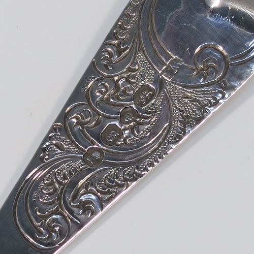 A very pretty pair of Antique Georgian Sterling Silver berry serving spoons, having hand-chased handles with floral and scroll decoration, and hand-chased bowls with gold-gilt fruit decoration, all in their original light blue satin-lined presentation box. These beautiful silver serving spoons were made by William Eley of London in 1782. The dimensions of this fine hand-made pair of antique silver berry spoons are length 22.5cms (8.75 inches), and they weigh a total of approx. 124g (4 troy ounces).   