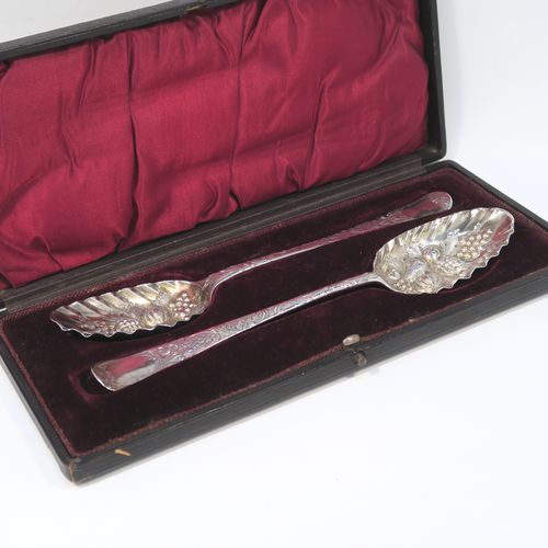A very pretty pair of Antique Georgian Sterling Silver and gold-gilt berry serving spoons, having hand-chased handles with floral and scroll decoration, and gold-gilt hand-chased fluted bowls with fruit decoration, all in their original maroon satin and velvet-lined presentation box. These beautiful antique silver berry serving spoons were made by John Lampfelt of London in ca. 1770. The dimensions of this fine hand-made pair of antique silver berry spoons are length 22cms (8.75 inches), and they weigh a total of approx. 115g (3.7 troy ounces).   