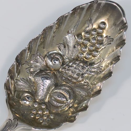 A very pretty pair of Antique Georgian Sterling Silver and gold-gilt berry serving spoons, having hand-chased handles with floral and scroll decoration, and gold-gilt hand-chased fluted bowls with fruit decoration, all in their original maroon satin and velvet-lined presentation box. These beautiful antique silver berry serving spoons were made by John Lampfelt of London in ca. 1770. The dimensions of this fine hand-made pair of antique silver berry spoons are length 22cms (8.75 inches), and they weigh a total of approx. 115g (3.7 troy ounces).   