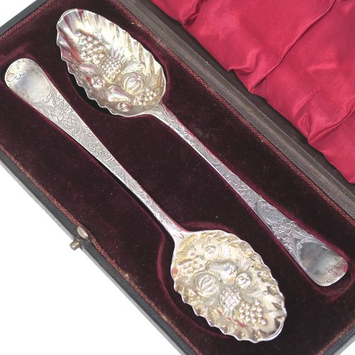 A very pretty pair of Antique Georgian Sterling Silver and gold-gilt berry serving spoons, having hand-chased handles with floral and scroll decoration, and gold-gilt hand-chased fluted bowls with fruit decoration, all in their original maroon satin and velvet-lined presentation box. These beautiful antique silver berry serving spoons were made by John Lampfelt of London in ca. 1770. The dimensions of this fine hand-made pair of antique silver berry spoons are length 22cms (8.75 inches), and they weigh a total of approx. 115g (3.7 troy ounces).   