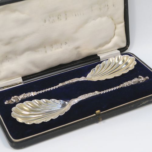A beautiful pair of Antique Victorian Sterling Silver serving spoons, having cast handles with figural Apostle ends and twisted stems, and fluted oval bowls with a gold-gilt wash. These wonderful silver serving spoons were made by William Hutton and Sons of London in 1894. The dimensions of this fine hand-made pair of antique silver serving spoons are length 20cms (8 inches), and they weigh a total of approx. 130g (4.2 troy ounces).  