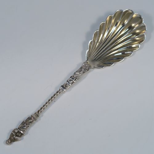 A beautiful pair of Antique Victorian Sterling Silver serving spoons, having cast handles with figural Apostle ends and twisted stems, and fluted oval bowls with a gold-gilt wash. These wonderful silver serving spoons were made by William Hutton and Sons of London in 1894. The dimensions of this fine hand-made pair of antique silver serving spoons are length 20cms (8 inches), and they weigh a total of approx. 130g (4.2 troy ounces).