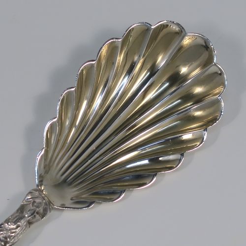A beautiful pair of Antique Victorian Sterling Silver serving spoons, having cast handles with figural Apostle ends and twisted stems, and fluted oval bowls with a gold-gilt wash. These wonderful silver serving spoons were made by William Hutton and Sons of London in 1894. The dimensions of this fine hand-made pair of antique silver serving spoons are length 20cms (8 inches), and they weigh a total of approx. 130g (4.2 troy ounces).