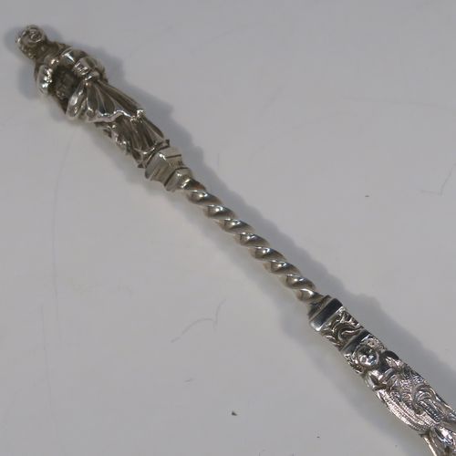 A beautiful pair of Antique Victorian Sterling Silver serving spoons, having cast handles with figural Apostle ends and twisted stems, and fluted oval bowls with a gold-gilt wash. These wonderful silver serving spoons were made by William Hutton and Sons of London in 1894. The dimensions of this fine hand-made pair of antique silver serving spoons are length 20cms (8 inches), and they weigh a total of approx. 130g (4.2 troy ounces).