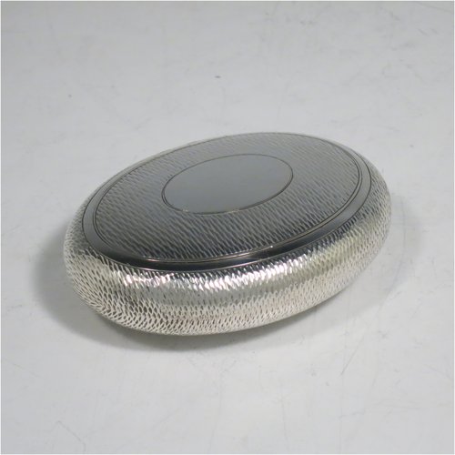 An Antique Edwardian Sterling Silver tobacco box, having an oval body, with engine-turned decoration, a vacant cartouche, a squeeze-action sprung hinged lid, and a gold-gilt interior. Made by Horton & Allday of Birmingham in 1903. The dimensions of this fine hand-made silver tobacco box are length 8 cms (3.25 inches), width 6 cms (2.3 inches), and it weighs approx. 62g (2 troy ounces).   