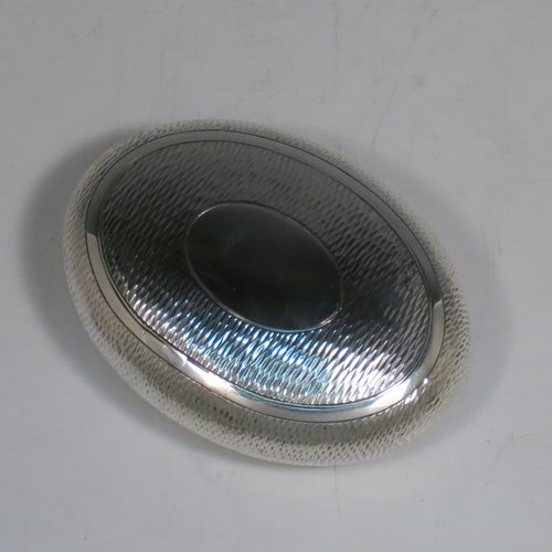 An Antique Edwardian Sterling Silver tobacco box, having an oval body, with engine-turned decoration, a vacant cartouche, a squeeze-action sprung hinged lid, and a gold-gilt interior. Made by Horton & Allday of Birmingham in 1903. The dimensions of this fine hand-made silver tobacco box are length 8 cms (3.25 inches), width 6 cms (2.3 inches), and it weighs approx. 62g (2 troy ounces).