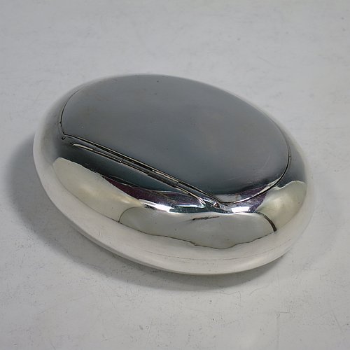 An Antique Victorian Sterling Silver tobacco box, having a plain oval body, and squeeze-action sprung hinged lid. Made by Elkington & Co., of Birmingham in 1901. The dimensions of this fine hand-made antique silver tobacco box are length 9 cms (3.5 inches), width 6.5 cms (2.5 inches), depth 3 cms (1.25 inches), and it weighs approx. 102g (3.3 troy ounces).