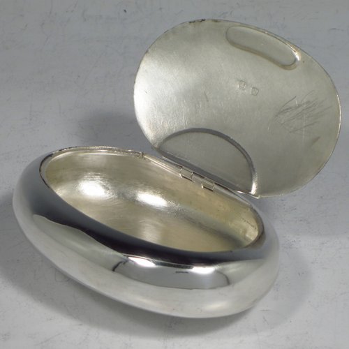 An Antique Victorian Sterling silver tobacco box, having a plain oval body, and squeeze-action sprung hinged lid. Made by Saunders & Shepherd of Birmingham in 1896. The dimensions of this fine hand-made silver tobacco box are length 8.5 cms (3.3 inches), depth 2.5 cms (1.0 inches), and it weighs approx. 75g (2.4 troy ounces).