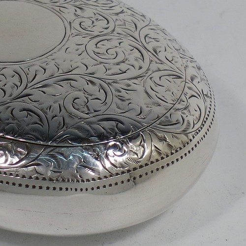 A very pretty Antique Edwardian Sterling Silver tobacco box, having an oval body, with hand-engraved floral and scroll decoration, a vacant cartouche, a squeeze-action sprung hinged lid, and a gold-gilt interior. Made by James Round of Birmingham in 1910. The dimensions of this fine hand-made antique silver tobacco box are length 8 cms (3.25 inches), width 6 cms (2.3 inches), and it weighs approx. 78g (2.5 troy ounces).