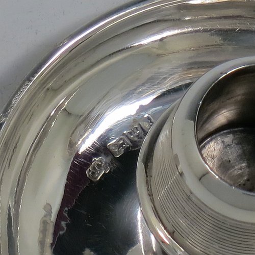 An Antique Edwardian Sterling Silver combination match holder, striker, and ash-tray, having a plain round body, with three cigarette holders, and a central match holder with sloping striker sides, and all sitting on a flat base. Made by Charles Cooke of Chester in 1902. The dimensions of this fine hand-made antique silver match striker and ash-tray are diameter 7.5 cms (3 inches), height 6 cms (2.3 inches), and it weighs approx. 60g (2 troy ounces).