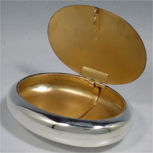 A large Antique Victorian Sterling Silver tobacco box, having a plain oval body with a gold-gilt interior, and squeeze-action sprung hinged lid with flat invisible hinge. Made by Horton & Allday of Birmingham in 1901. The dimensions of this fine hand-made antique silver tobacco box are length 11 cms (4.25 inches), width 8 cms (3.25 inches), depth 2.5 cms (1 inch), and it weighs approx. 119g (3.8 troy ounces).