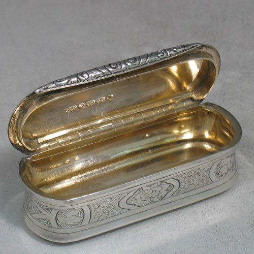 Antique Victorian sterling silver and gold-gilt snuff box made by George Unite of London in 1872. Originally presented to Joseph Wyatt, who we believe was the head groundsman of Wellbeck house. Hand engraved with floral work, and with three panels on base that have a thistle (for Scotland), a rose (for England), and a shamrock (for Ireland). Length 9 cms.