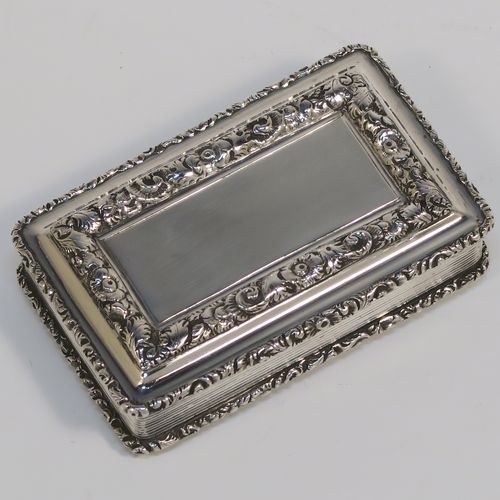 A beautiful Antique late Georgian Sterling silver large and heavy snuff box, having a rectangular body with hand-chased reeded decoration, with applied cast foliate borders, and a gold-gilt interior. This elegant antique silver snuff box was made by Nathaniel Mills of Birmingham in 1834. The dimensions of this fine hand-made antique silver snuff box are length 7 cms (2.75 inches), width 4.5 cms (1.75 inches), depth 2 cms (0.75 inch), and it weighs approx. 94g (3 troy ounces).