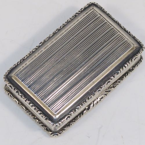 A beautiful Antique late Georgian Sterling silver large and heavy snuff box, having a rectangular body with hand-chased reeded decoration, with applied cast foliate borders, and a gold-gilt interior. This elegant antique silver snuff box was made by Nathaniel Mills of Birmingham in 1834. The dimensions of this fine hand-made antique silver snuff box are length 7 cms (2.75 inches), width 4.5 cms (1.75 inches), depth 2 cms (0.75 inch), and it weighs approx. 94g (3 troy ounces).