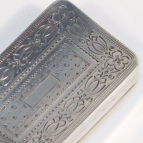 An elegant Antique Georgian Sterling Silver snuff box, having a rectangular body, with a slightly curved profile for holding in a waist-coat pocket, with hand-engraved geometrical & floral decoration, with a vacant rectangular cartouche on one side, a hinged lid and a gold-gilt interior. This beautiful antique silver snuff box was made by Joseph Willmore of Birmingham in 1826. The dimensions of this fine hand-made silver box are length 5.5 cms (2.25 inches), width 3.5 cms (1.3 inches), and it weighs approx. 27g (0.9 troy ounces).