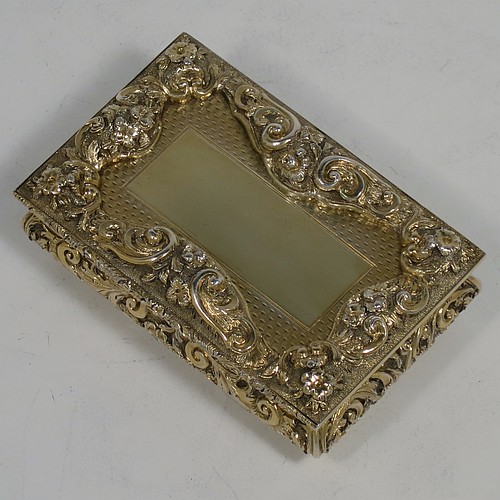 A rare and beautiful Antique Victorian Sterling Silver and gold-gilt large and heavy snuff box, having a rectangular body with applied cast foliate borders, a hinged lid with an applied panel with foliate border and vacant cartouche, the base with an applied panel having hand-engraved foliate & geometrical decoration, the sides with hand-chased floral work. Made by Fredrick Marson of Birmingham in 1848. The dimensions of this fine hand-made antique silver snuff box are length 9 cms (3.5 inches), width 6 cms (2.3 inches), depth 3 cms (1.25 inches), and it weighs approx. 167g (5.3 troy ounces).