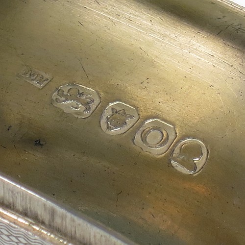 A very handsome Antique Georgian Sterling Silver snuff box, having a rectangular body which is also curved to fit the pocket, decorated with engine turning and hand-chased reeded borders, an applied thumb-piece, and with a gold gilt interior. The dimensions of this fine hand-made antique silver snuff box are length 7cm (2.75 inches), width 4.5 cms (1.75 inches), depth 2.3 cms (0.8 inches), and it weighs approx. 77g (2.5 troy ounces).