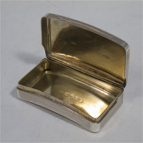A very handsome Antique Georgian Sterling Silver snuff box, having a rectangular body which is also curved to fit the pocket, decorated with engine turning and hand-chased reeded borders, an applied thumb-piece, and with a gold gilt interior. The dimensions of this fine hand-made antique silver snuff box are length 7cm (2.75 inches), width 4.5 cms (1.75 inches), depth 2.3 cms (0.8 inches), and it weighs approx. 77g (2.5 troy ounces).