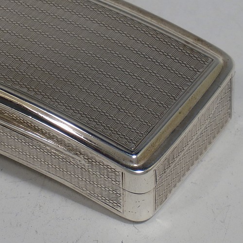 A very handsome Antique Georgian Sterling Silver snuff box, having a rectangular body which is also curved to fit the pocket, decorated with engine turning and hand-chased reeded borders, an applied thumb-piece, and with a gold gilt interior. The dimensions of this fine hand-made antique silver snuff box are length 7cm (2.75 inches), width 4.5 cms (1.75 inches), depth 2.3 cms (0.8 inches), and it weighs approx. 77g (2.5 troy ounces).