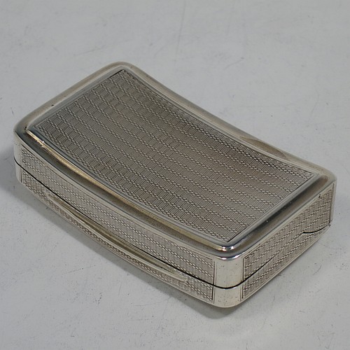 A very handsome Antique Georgian Sterling Silver snuff box, having a rectangular body which is also curved to fit the pocket, decorated with engine turning and hand-chased reeded borders, an applied thumb-piece, and with a gold gilt interior. The dimensions of this fine hand-made antique silver snuff box are length 7cm (2.75 inches), width 4.5 cms (1.75 inches), depth 2.3 cms (0.8 inches), and it weighs approx. 77g (2.5 troy ounces).