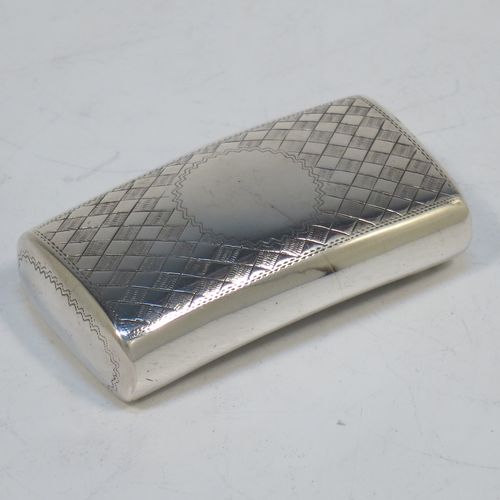 A rare and handsome Irish Antique Georgian Sterling Silver snuff box, having a rectangular body, with a slightly curved profile for holding in a waist-coat pocket, with hand-engraved geometrical & floral decoration, a vacant round cartouche on one side, and a flat invisibly hinged lid with thumb-piece. Made in Dublin, Ireland, in 1820. The dimensions of this fine hand-made antique Irish silver snuff box are length 5.5 cms (2.25 inches), width 3 cms (01.25 inches), and it weighs approx. 25g (0.8 troy ounces).   