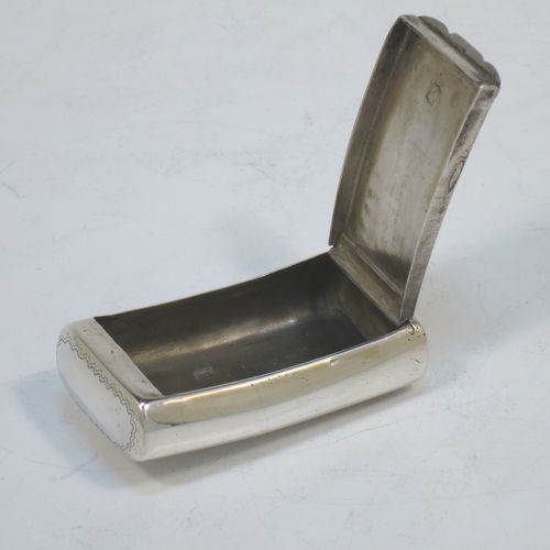 A rare and handsome Irish Antique Georgian Sterling Silver snuff box, having a rectangular body, with a slightly curved profile for holding in a waist-coat pocket, with hand-engraved geometrical & floral decoration, a vacant round cartouche on one side, and a flat invisibly hinged lid with thumb-piece. Made in Dublin, Ireland, in 1820. The dimensions of this fine hand-made antique Irish silver snuff box are length 5.5 cms (2.25 inches), width 3 cms (01.25 inches), and it weighs approx. 25g (0.8 troy ounces).