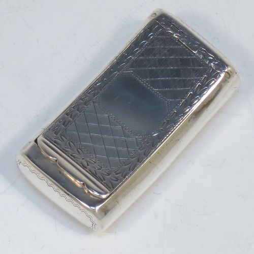 A rare and handsome Irish Antique Georgian Sterling Silver snuff box, having a rectangular body, with a slightly curved profile for holding in a waist-coat pocket, with hand-engraved geometrical & floral decoration, a vacant round cartouche on one side, and a flat invisibly hinged lid with thumb-piece. Made in Dublin, Ireland, in 1820. The dimensions of this fine hand-made antique Irish silver snuff box are length 5.5 cms (2.25 inches), width 3 cms (01.25 inches), and it weighs approx. 25g (0.8 troy ounces).