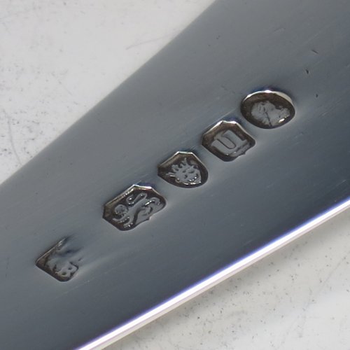 An Antique Georgian Sterling Silver soup ladle in the Old English pattern, having a plain handle with a pip on the reverse, and a plain round bowl with a heel on the reverse. Made by Peter & Anne Bateman of London in 1795. The dimensions of this fine hand-made silver soup ladle are length 34 cms (13.5 inches), and it weighs approx. 185g (6 troy ounces).