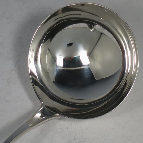 An Antique Georgian Sterling Silver soup ladle in the Old English pattern, having a plain handle with a pip on the reverse, and a plain round bowl with a heel on the reverse. Made by Peter & Anne Bateman of London in 1795. The dimensions of this fine hand-made silver soup ladle are length 34 cms (13.5 inches), and it weighs approx. 185g (6 troy ounces).