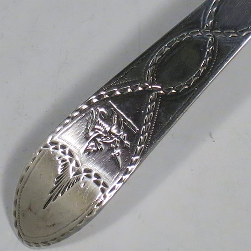 An Antique Georgian Sterling Silver large Irish soup ladle in the Irish Bright-Cut pattern, having a hand-engraved handle with bright-cut decoration, and a hand-chased shell style round bowl. Made in Dublin in 1794. The dimensions of this fine hand-made antique silver soup ladle are length 34 cms (13.3 inches), and it weighs approx. 159g (5.1 troy ounces). Please note that this item is crested.