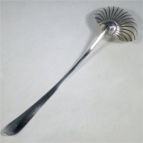 An Antique Georgian Sterling Silver large Irish soup ladle in the Irish Bright-Cut pattern, having a hand-engraved handle with bright-cut decoration, and a hand-chased shell style round bowl. Made in Dublin in 1794. The dimensions of this fine hand-made antique silver soup ladle are length 34 cms (13.3 inches), and it weighs approx. 159g (5.1 troy ounces). Please note that this item is crested.