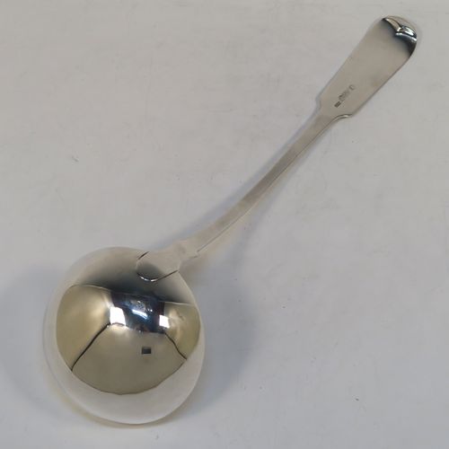 A very handsome Antique Scottish Georgian (William IV) Sterling Silver soup ladle in the Fiddle pattern, having a plain handle with a pip on the reverse, and a plain oval bowl with a heel on the reverse. This elegant antique silver soup ladle was made by James McKay of Edinburgh in 1836. The dimensions of this fine hand-made antique silver soup ladle are length 34.5 cms (13.5 inches), and it weighs approx. 248g (8 troy ounces).