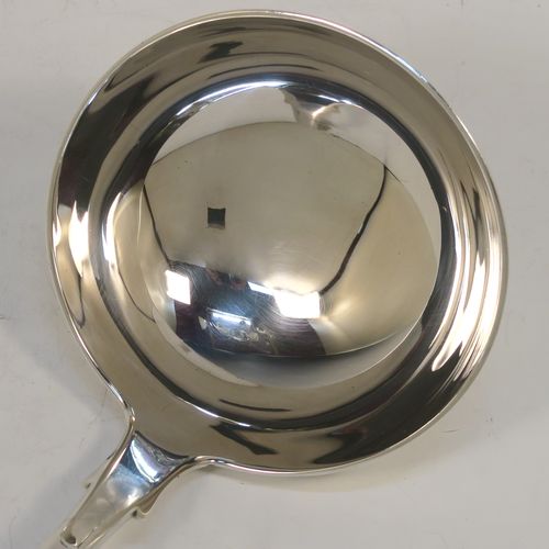 A very handsome Antique Scottish Georgian (William IV) Sterling Silver soup ladle in the Fiddle pattern, having a plain handle with a pip on the reverse, and a plain oval bowl with a heel on the reverse. This elegant antique silver soup ladle was made by James McKay of Edinburgh in 1836. The dimensions of this fine hand-made antique silver soup ladle are length 34.5 cms (13.5 inches), and it weighs approx. 248g (8 troy ounces).