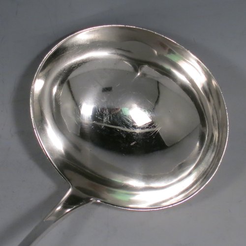 An Antique Georgian Sterling Silver soup ladle in the Old English pattern, having a plain handle with a pip on the reverse, and a plain round bowl. Made by Thomas Wallis II & Jonathan Hayne of London in 1813. The dimensions of this fine hand-made silver soup ladle are length 33 cms (13 inches), and it weighs approx. 168g (5.4 troy ounces).