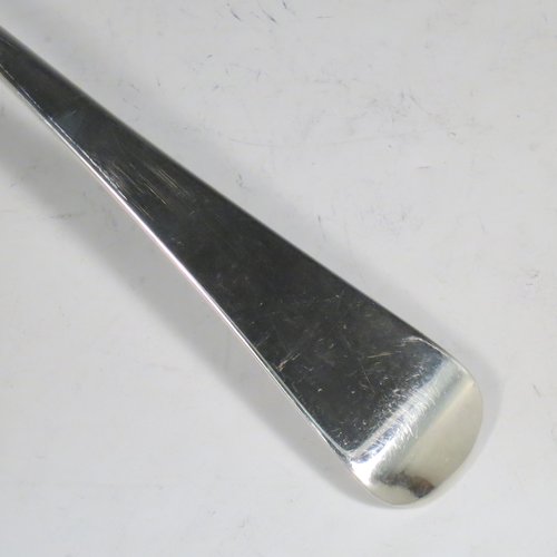 An Antique Georgian Sterling Silver soup ladle in the Old English pattern, having a plain handle with a pip on the reverse, and a plain round bowl. Made by Thomas Wallis II & Jonathan Hayne of London in 1813. The dimensions of this fine hand-made silver soup ladle are length 33 cms (13 inches), and it weighs approx. 168g (5.4 troy ounces).