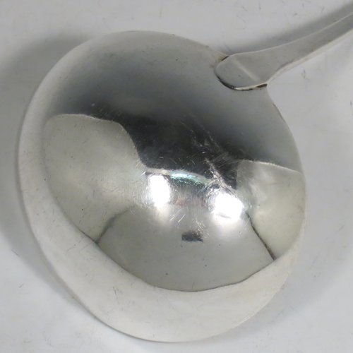 An Antique Georgian Sterling Silver soup ladle in the Old English pattern, having a plain handle with a pip on the reverse, and a plain round bowl. Made by Thomas Wallis II & Jonathan Hayne of London in 1813. The dimensions of this fine hand-made silver soup ladle are length 33 cms (13 inches), and it weighs approx. 168g (5.4 troy ounces).