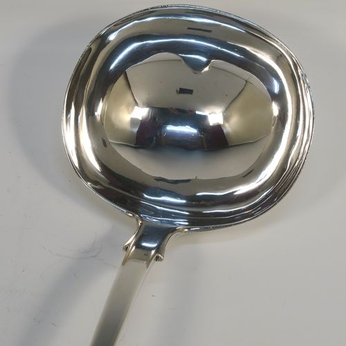 A heavy and elegant Antique Victorian Sterling Silver soup ladle in the Fiddle pattern, having a plain handle with a pip on the reverse, and a plain round bowl with shoulders above and a heel on the reverse. This handsome silver soup ladle was made by William Smiley of London in 1851. The dimensions of this fine hand-made antique silver soup ladle are length 36.5 cms (14.3 inches), and it weighs approx. 300g (9.7 troy ounces).   
