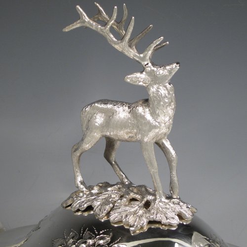 Antique Victorian silver plated soup tureen, having a pull-off lid with a cast model of a stag, with hand-chased floral decoration, applied bead-edged borders, two scroll side-handles, and all sitting on a pedestal foot. Made in ca. 1870. The dimensions of this fine hand-made silver-plated soup tureen and cover are height 33 cms (13 inches), length including handles 37 cms (14.5 inches), and width 20 cms (8 inches).