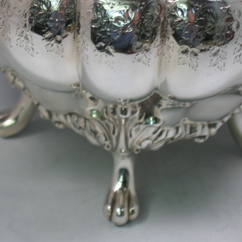 An Antique Victorian Silver Plated soup tureen, having a hand-chased and engraved body with melon-style lobes and floral decoration, a pull-off cover with cast finial, with two reeded loop side-handles, and all sitting on four cast foliate feet. Made by the Mappin Brothers in ca. 1870. The dimensions of this fine hand-made antique silver-plated soup tureen are height 26 cms (10.25 inches), and width (across handles) 37 cms (14.5 inches).