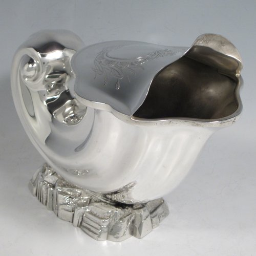 Antique Victorian silver plated spoon warmer, in the shape of a Cornucopia shell, having a hand-chased body with asymmetrical opening, a vacant cartouche with hand-engraved reed-work decoration, and all sitting on a cast rock base. Made by Henry Wilkinson of Sheffield in ca. 1880. The dimensions of this fine hand-made silver-plated spoon warmer are length 19 cms (7.5 inches), height 15 cms (6 inches), and width 10 cms (4 inches).