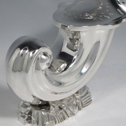 Antique Victorian silver plated spoon warmer, in the shape of a Cornucopia shell, having a hand-chased body with asymmetrical opening, a vacant cartouche with hand-engraved reed-work decoration, and all sitting on a cast rock base. Made by Henry Wilkinson of Sheffield in ca. 1880. The dimensions of this fine hand-made silver-plated spoon warmer are length 19 cms (7.5 inches), height 15 cms (6 inches), and width 10 cms (4 inches).