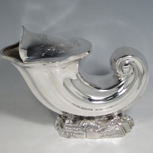 Antique Victorian silver plated spoon warmer, in the shape of a Cornucopia shell, having a hand-chased body with asymmetrical opening, a vacant cartouche with hand-engraved reed-work decoration, and all sitting on a cast rock base. Made by Henry Wilkinson of Sheffield in ca. 1880. The dimensions of this fine hand-made silver-plated spoon warmer are length 19 cms (7.5 inches), height 15 cms (6 inches), and width 10 cms (4 inches).
