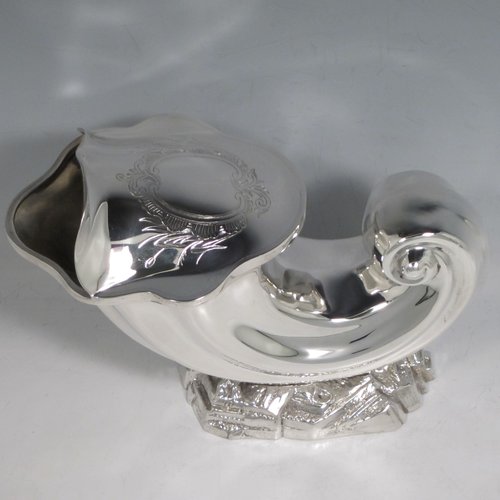 Antique Victorian silver plated spoon warmer, in the shape of a Cornucopia shell, having a hand-chased body with asymmetrical opening, a vacant cartouche with hand-engraved reed-work decoration, and all sitting on a cast rock base. Made by Henry Wilkinson of Sheffield in ca. 1880. The dimensions of this fine hand-made silver-plated spoon warmer are length 19 cms (7.5 inches), height 15 cms (6 inches), and width 10 cms (4 inches).