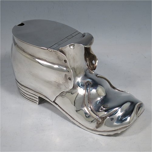 An Antique Victorian Silver Plated spoon warmer, in the shape of a leather shoe, having a hand-chased body with invisibly hinged lid opening, and all sitting on a hobnail boot base with heel. Made by Thomas Latham & Ernest Morton of Birmingham in ca. 1880. The dimensions of this fine hand-made silver-plated spoon warmer are length 16.5 cms (6.5 inches), height 9.5 cms (3.75 inches), and width 7 cms (2.75 inches).    