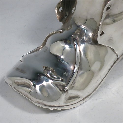An Antique Victorian Silver Plated spoon warmer, in the shape of a leather shoe, having a hand-chased body with invisibly hinged lid opening, and all sitting on a hobnail boot base with heel. Made by Thomas Latham & Ernest Morton of Birmingham in ca. 1880. The dimensions of this fine hand-made silver-plated spoon warmer are length 16.5 cms (6.5 inches), height 9.5 cms (3.75 inches), and width 7 cms (2.75 inches).